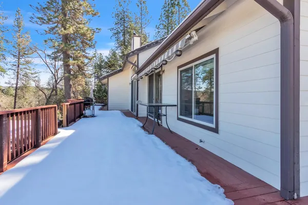 a view of a house with wooden deck front of house