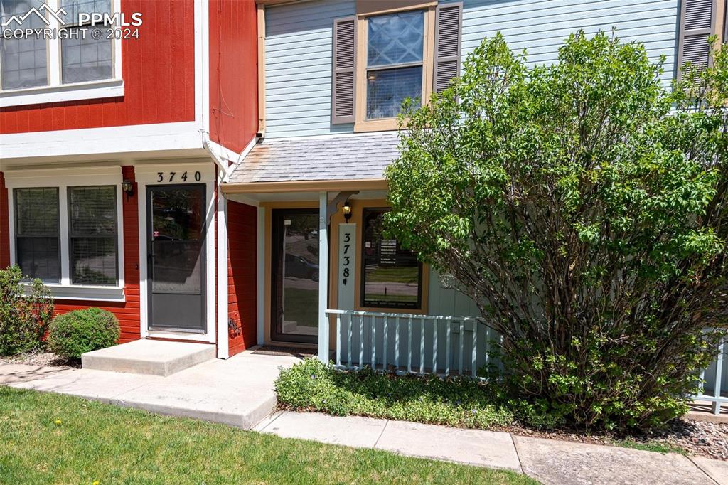 3738 Red Canon Place Colorado Springs, CO 80904 - Photo 20 of 27 a view of a house with a yard and potted plants