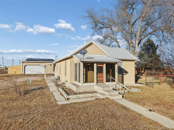 a front view of a house with a yard outdoor seating and barbeque oven