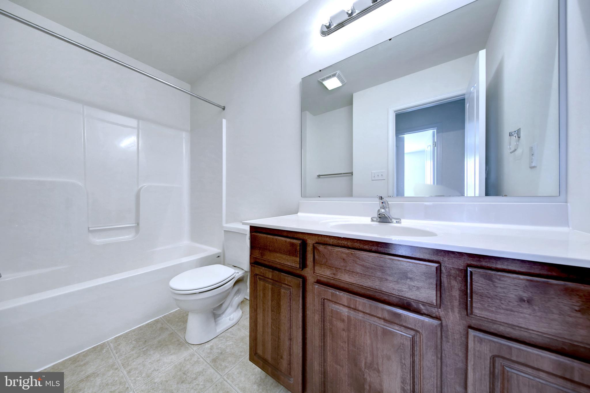 40 Mustang Drive Hanover, PA 17331 - Photo 13 of 19 a bathroom with a sink a toilet a mirror and bathtub
