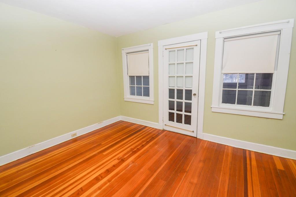 174 Pasco Road Springfield, MA 01151 - Photo 19 of 21 a view of an empty room with a window and wooden floor