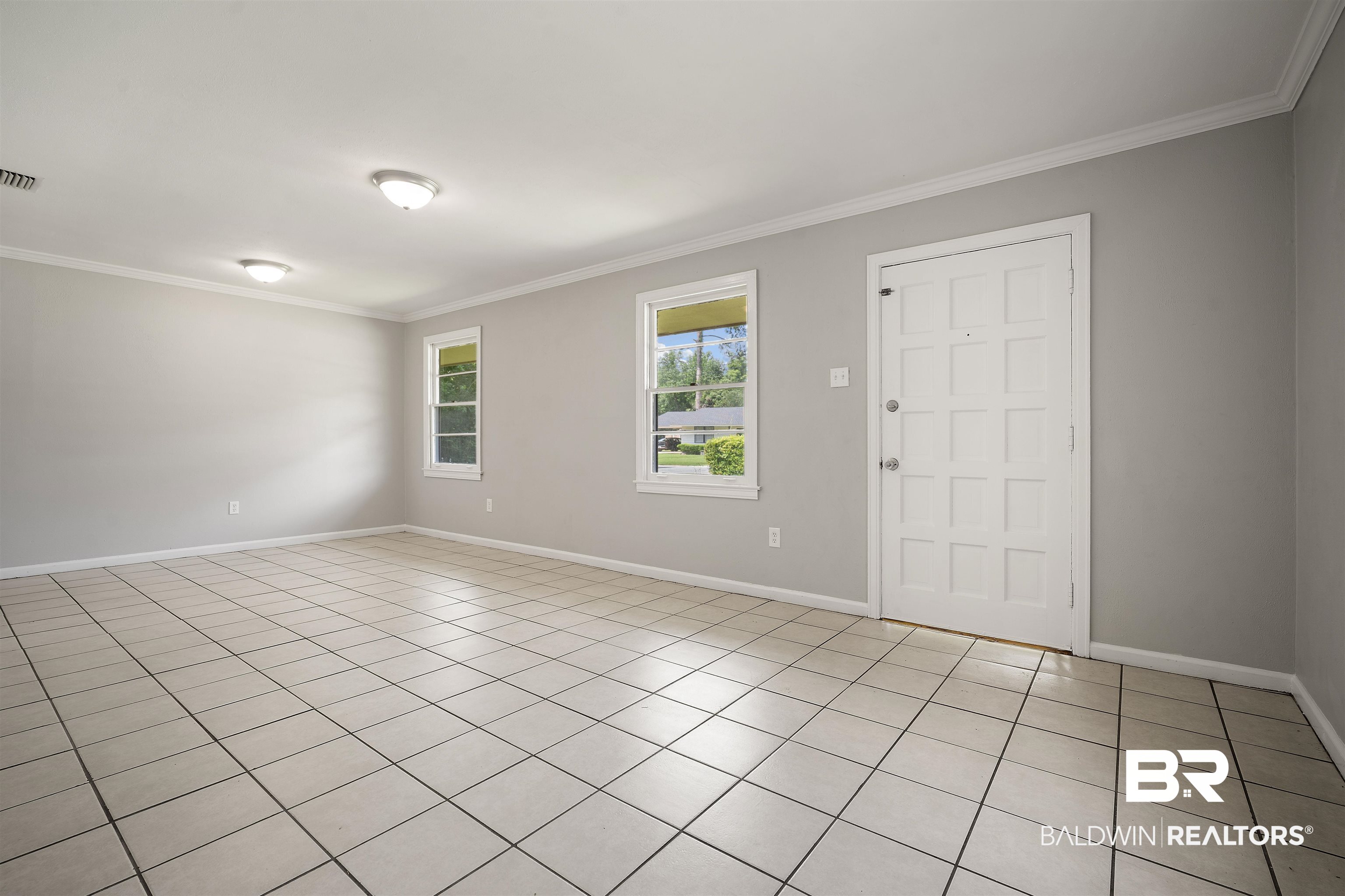 963 Shady Brook Drive Mobile, AL 36606 - Photo 4 of 20 Spare room featuring crown molding, baseboards, and light tile patterned floors