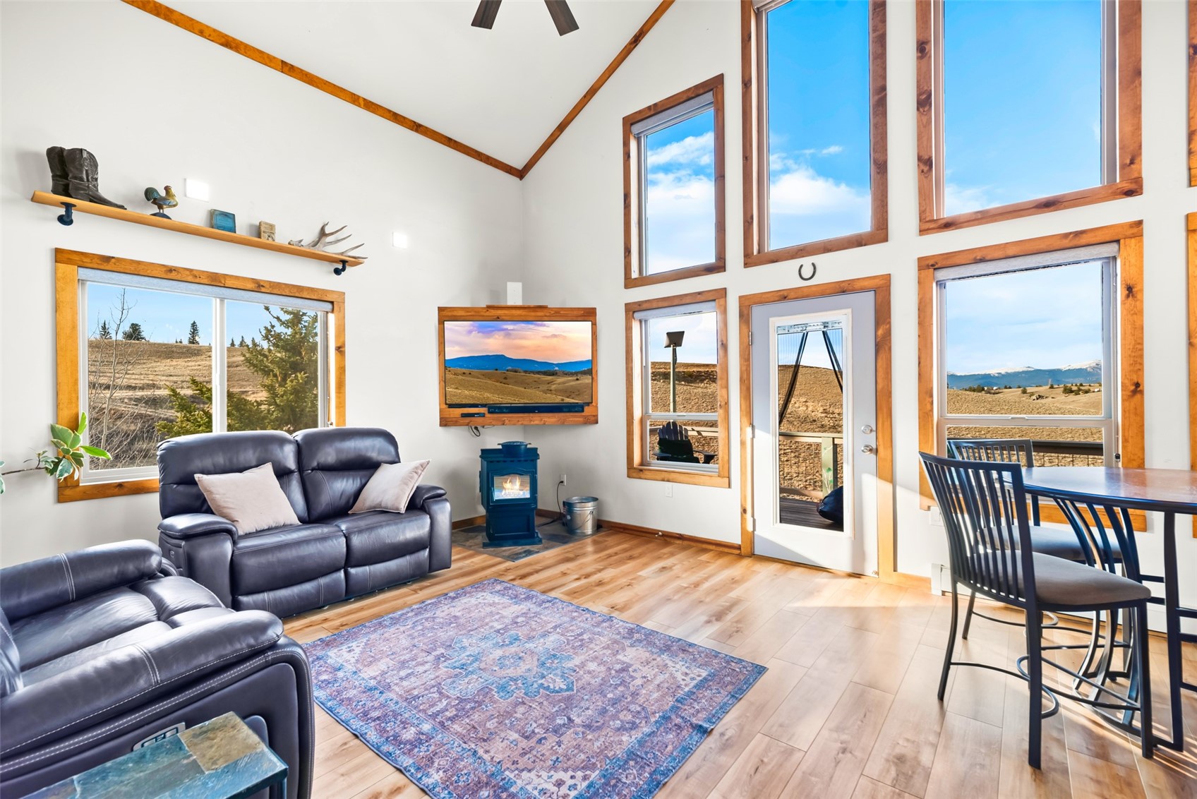 440 Arland Road Como, CO 80432 - Photo 12 of 49 a living room with furniture a flat screen tv and a floor to ceiling window