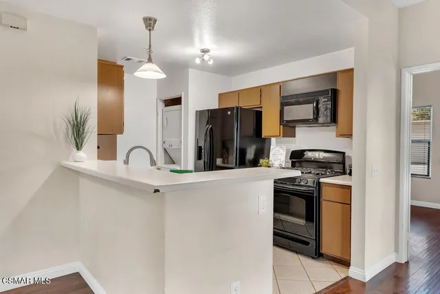 a kitchen with stainless steel appliances a sink stove and refrigerator