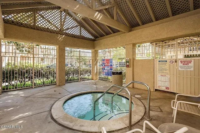 a view of a swimming pool with outdoor seating