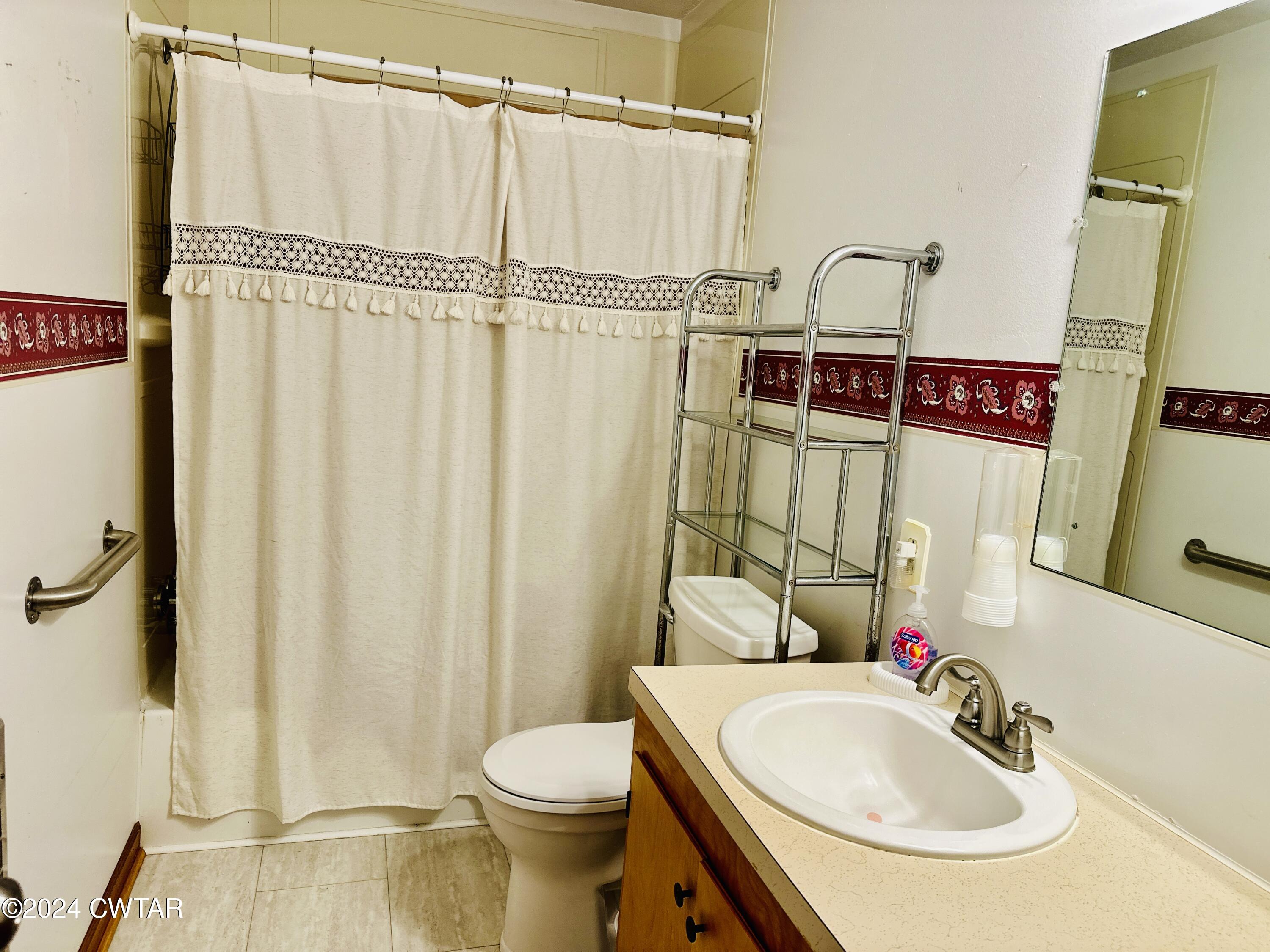 925 McKnight Street Rutherford, TN 38369 - Photo 13 of 23 a bathroom with a sink a toilet and shower curtain