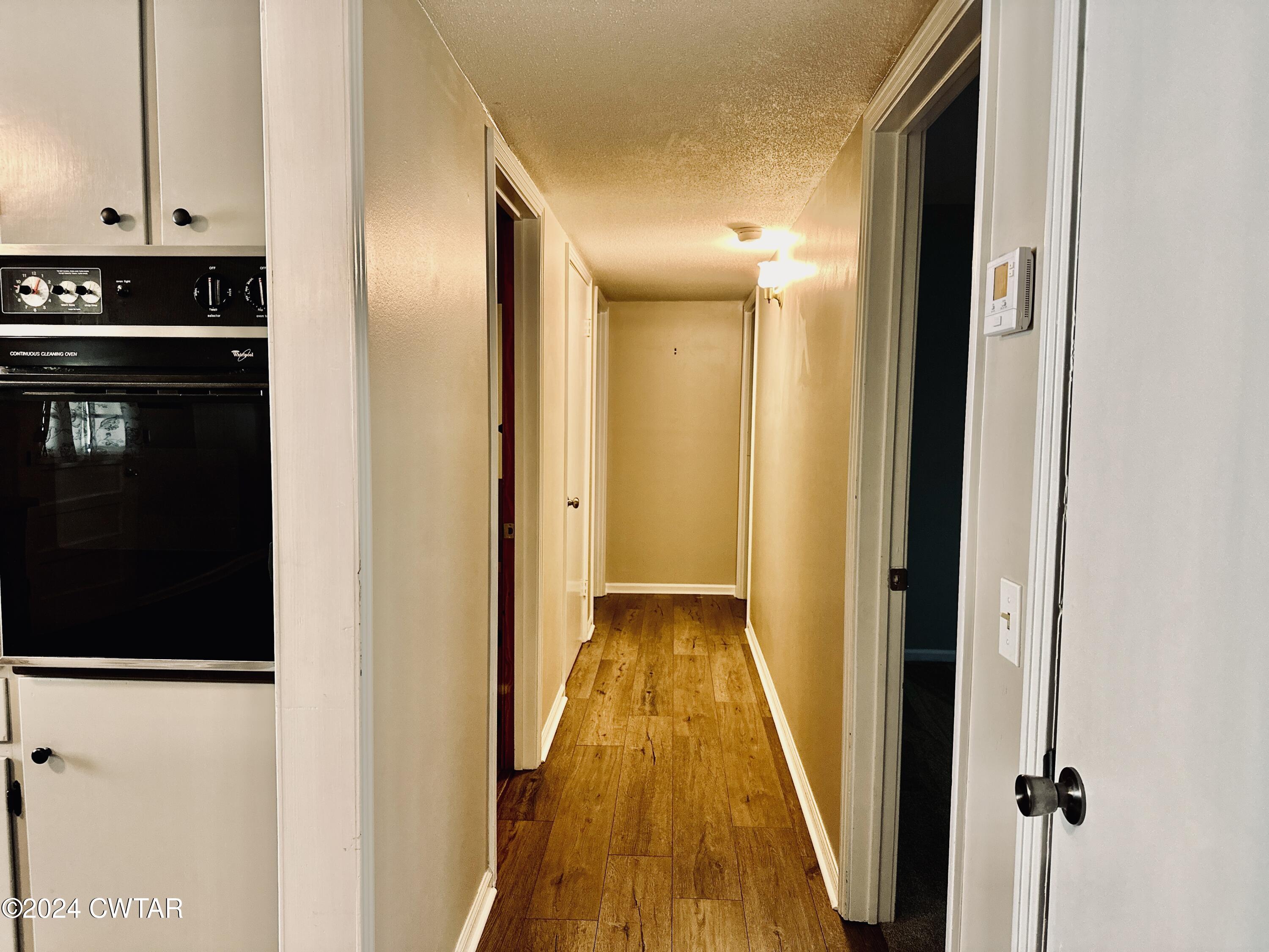 925 McKnight Street Rutherford, TN 38369 - Photo 17 of 23 a view of a hallway with wooden floor and a bathroom
