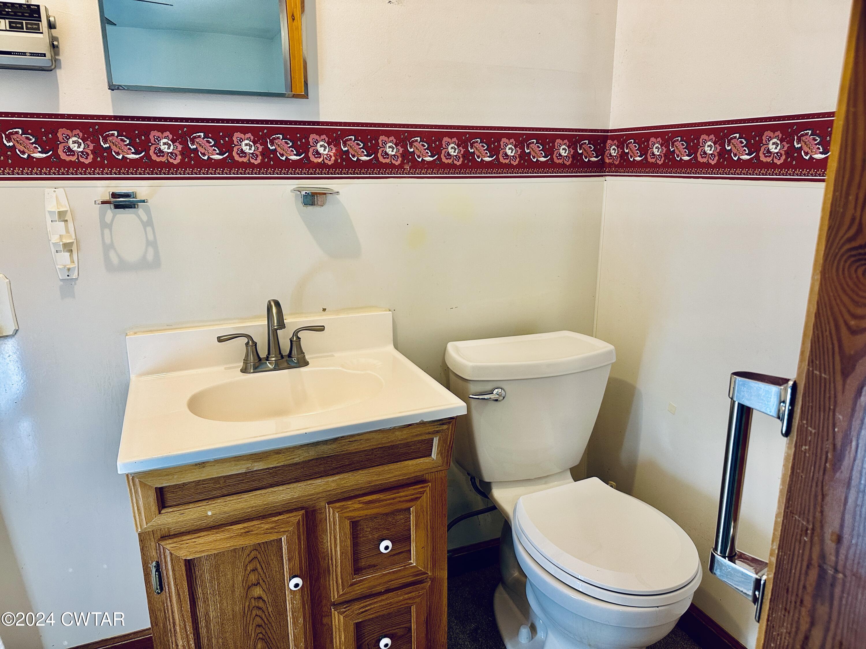 925 McKnight Street Rutherford, TN 38369 - Photo 23 of 23 a bathroom with a toilet a sink and wooden floor