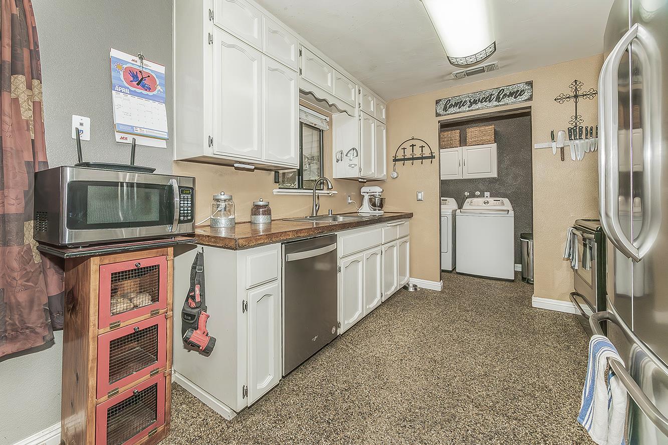 29545 Oak Meadow Road Tollhouse, CA 93667 - Photo 22 of 69 a kitchen with cabinets and stainless steel appliances
