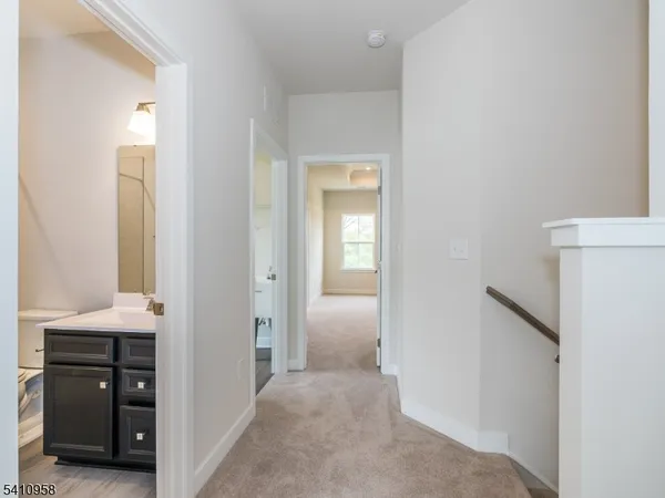 an empty room with windows and ceiling fan