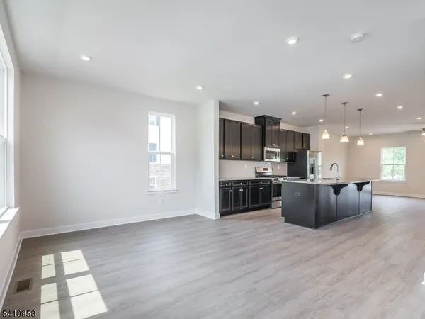 a large kitchen with stainless steel appliances granite countertop a large counter top and a stove