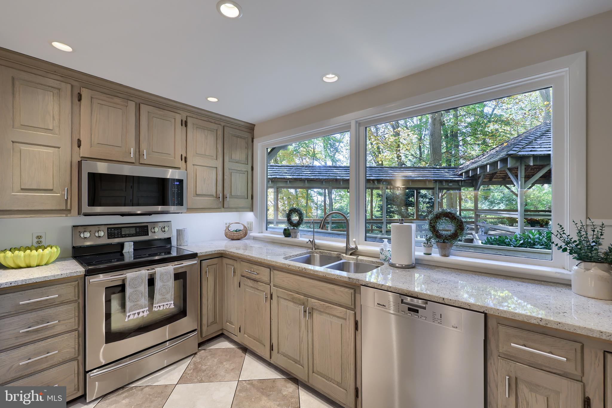 2487 Chestnut Ridge Drive Lancaster, PA 17601 - Photo 44 of 96 a kitchen with a sink a counter top space stainless steel appliances and a window