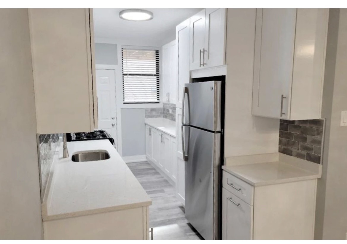 730 West Roscoe Street, Unit 2S Chicago, IL 60657 - Photo 4 of 10 a kitchen with a refrigerator sink and cabinets