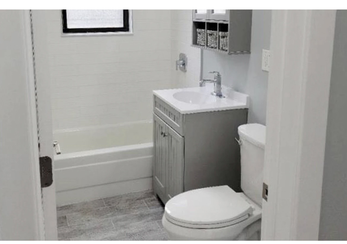 730 West Roscoe Street, Unit 2S Chicago, IL 60657 - Photo 8 of 10 a bathroom with a sink a toilet and shower