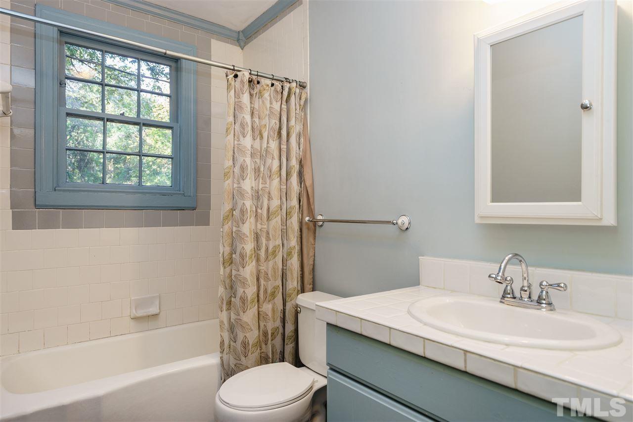 205 Lord Berkley Road Raleigh, NC 27610 - Photo 13 of 25 a bathroom with a granite countertop sink toilet and shower