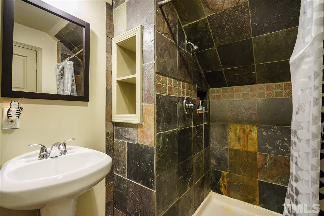 205 Lord Berkley Road Raleigh, NC 27610 - Photo 16 of 25 a bathroom with a sink toilet and shower