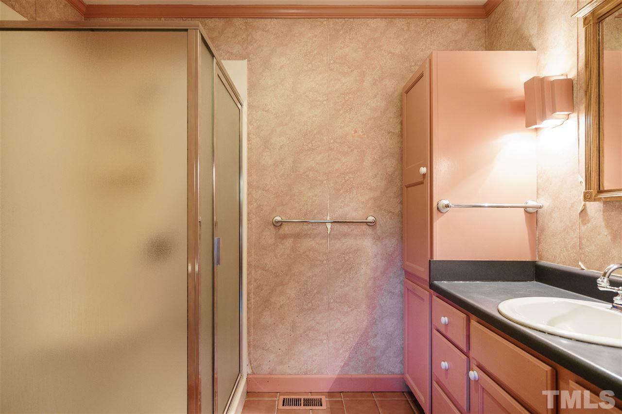 205 Lord Berkley Road Raleigh, NC 27610 - Photo 18 of 25 a bathroom with a granite countertop shower and a sink