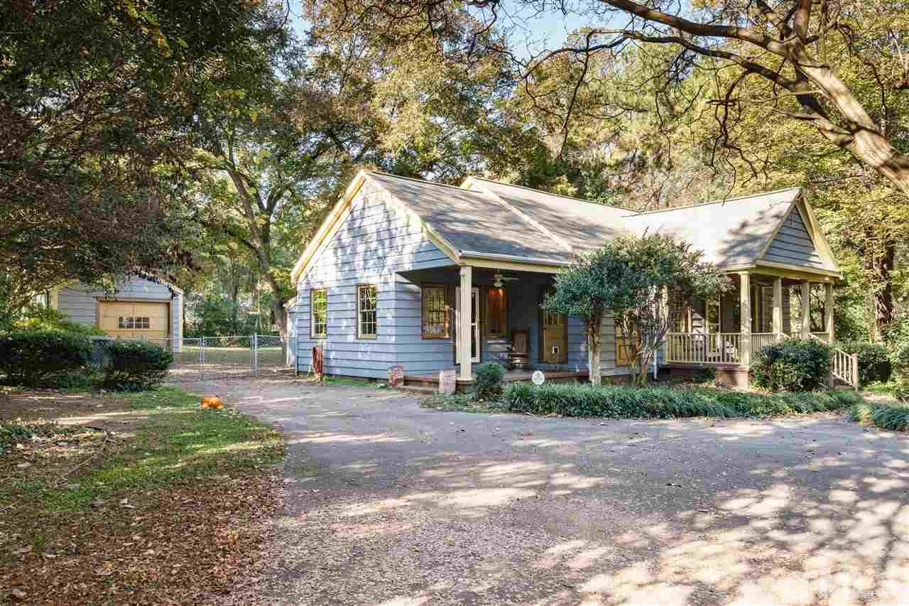 205 Lord Berkley Road Raleigh, NC 27610 - Photo 20 of 25 a front view of a house with a garden and trees