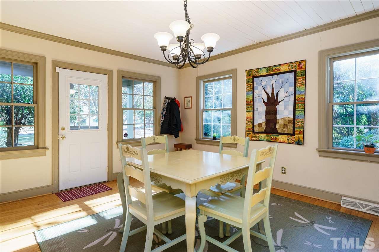 205 Lord Berkley Road Raleigh, NC 27610 - Photo 4 of 25 a view of a dining room with furniture a chandelier and wooden floor