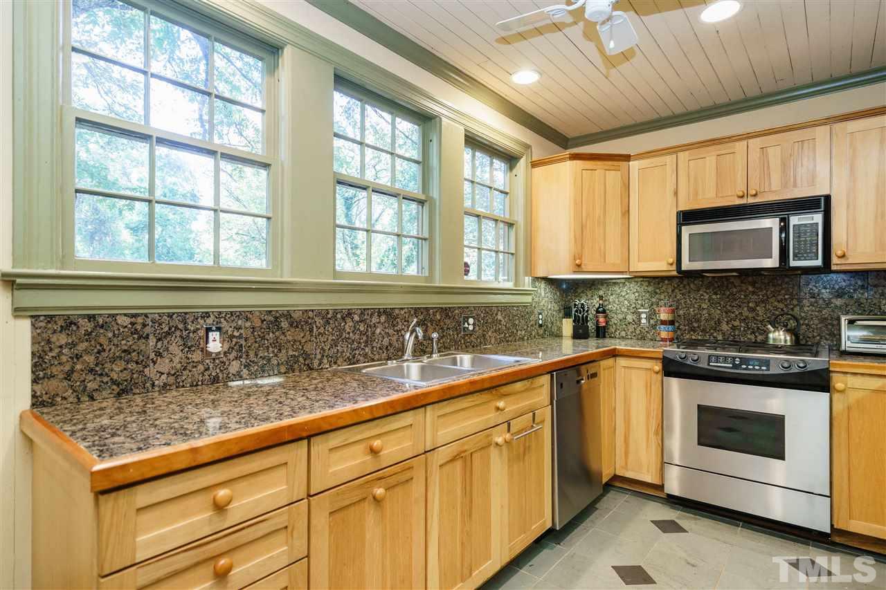 205 Lord Berkley Road Raleigh, NC 27610 - Photo 6 of 25 a kitchen with stainless steel appliances granite countertop a stove a sink and a microwave