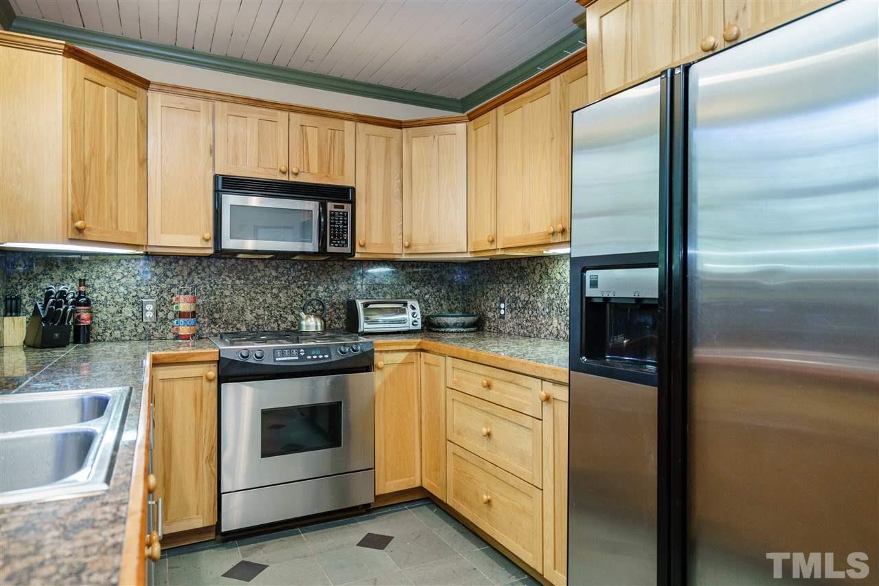 205 Lord Berkley Road Raleigh, NC 27610 - Photo 7 of 25 a kitchen with granite countertop cabinets stainless steel appliances and a sink