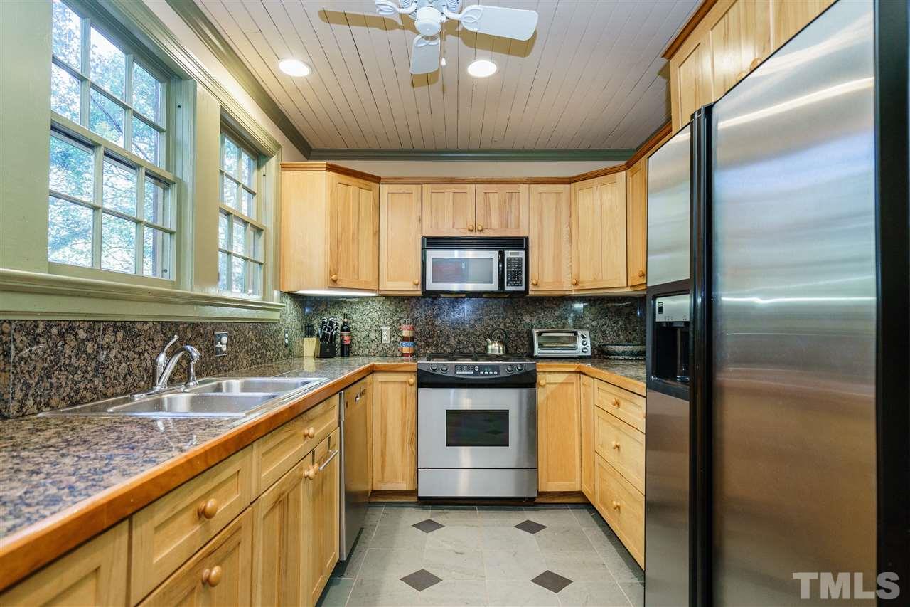 205 Lord Berkley Road Raleigh, NC 27610 - Photo 8 of 25 a kitchen with stainless steel appliances granite countertop a sink a stove and a refrigerator