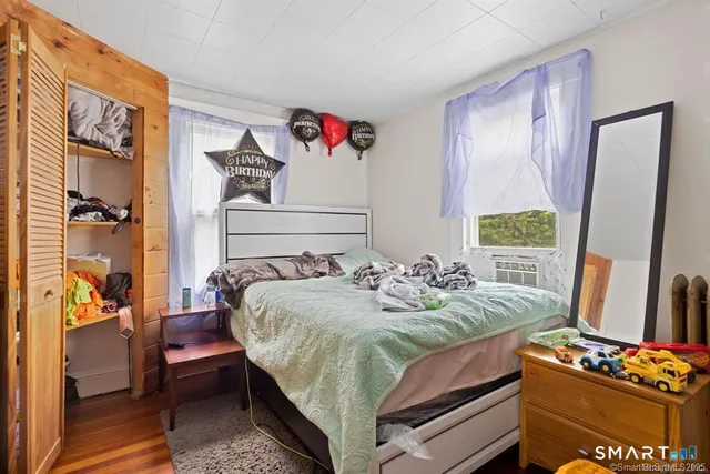 a bedroom with a bed and a window