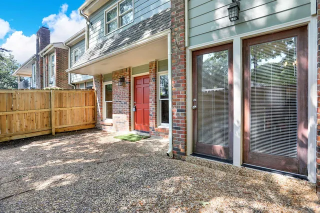 a view of a brick house with a large window