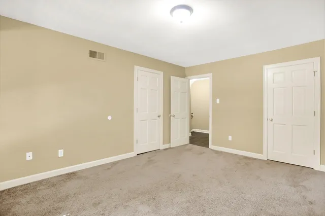 an empty room with closet area