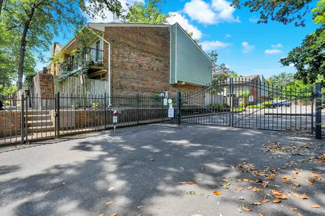a view of a house with a backyard and a tree