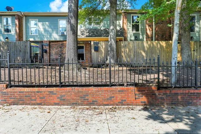 a view of a brick house with large windows