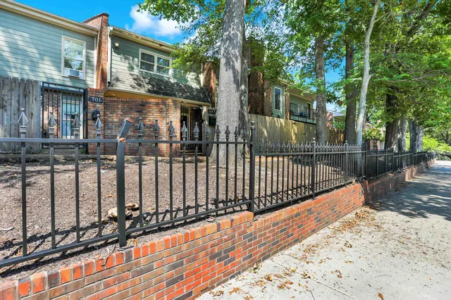 a view of street with wooden fence