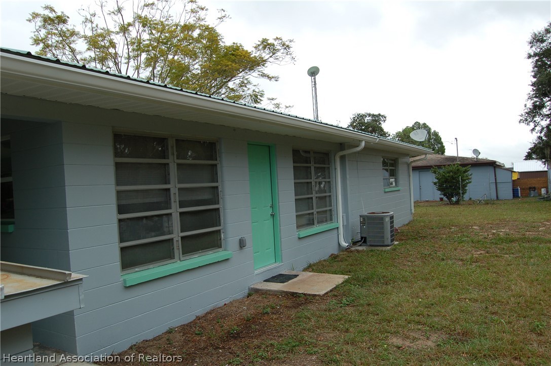 3029 West Verona Road Avon Park, FL 33825 - Photo 11 of 25 a view of a house with a yard and garage