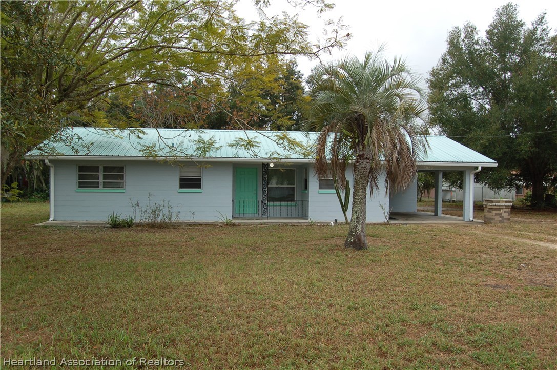 3029 West Verona Road Avon Park, FL 33825 - Photo 2 of 25 a front view of house with yard and trees