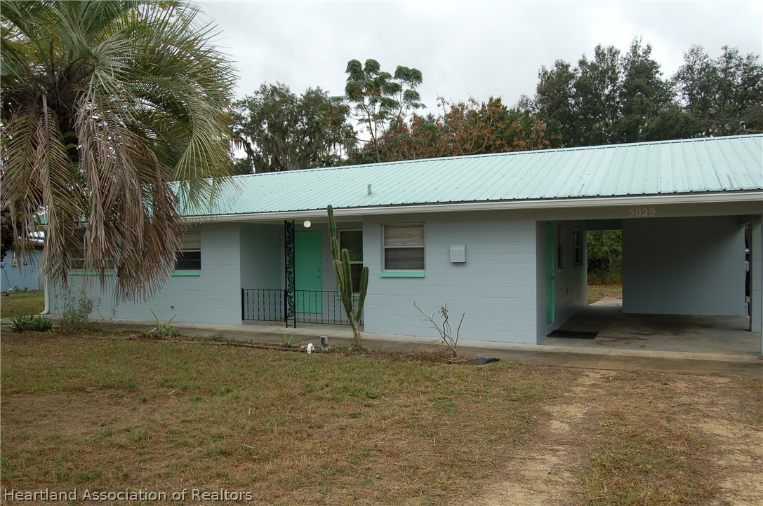 3029 West Verona Road Avon Park, FL 33825 - Photo 3 of 25 a house with trees in the background