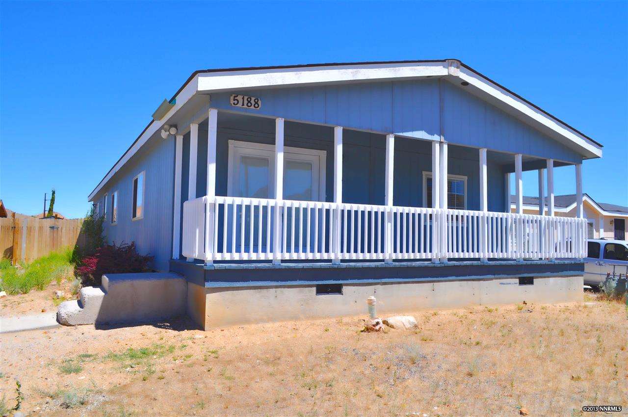a view of a house with wooden fence