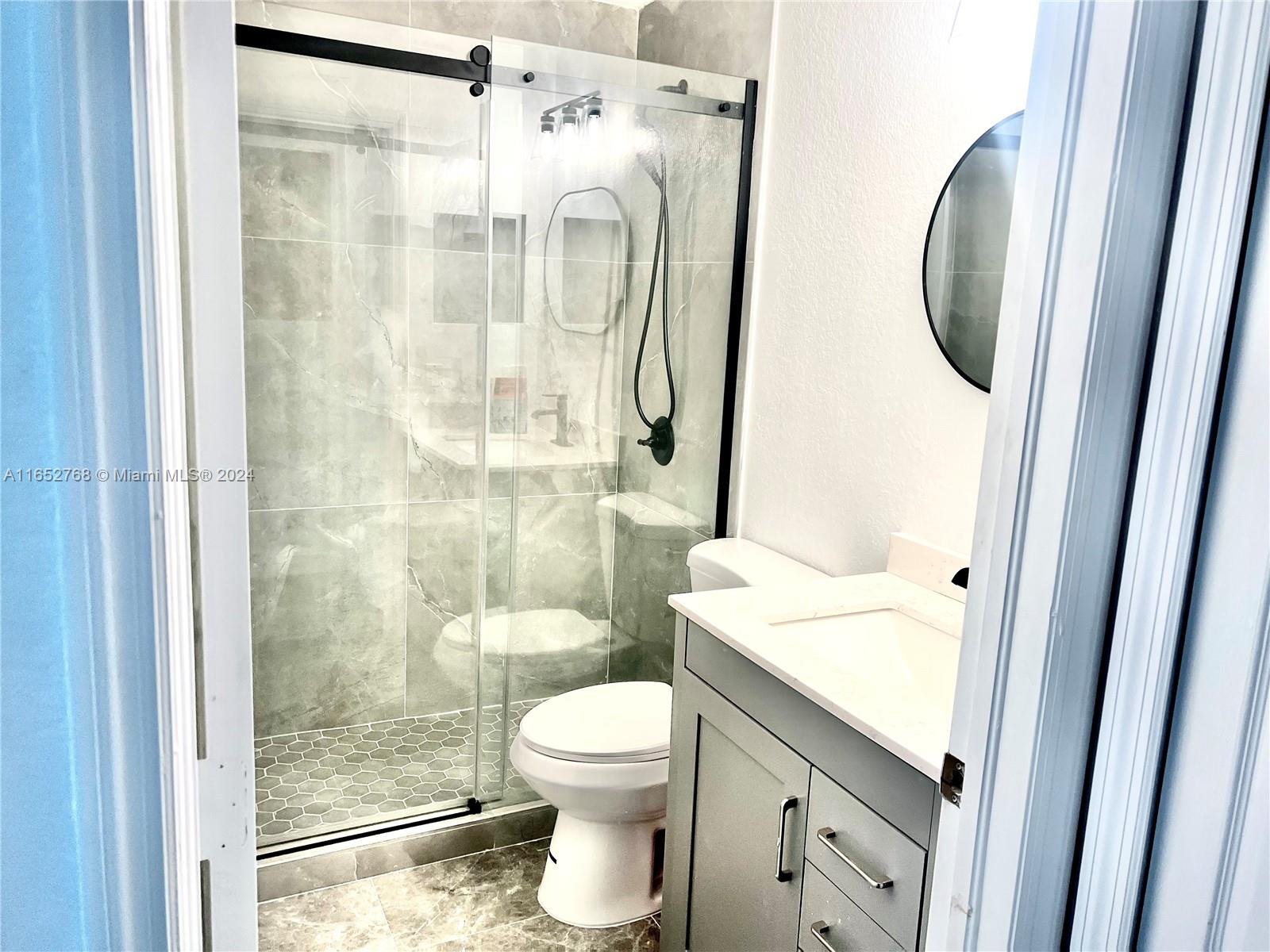 8924 West Flagler Street, Unit 2 Miami, FL 33174 - Photo 3 of 7 a bathroom with a granite countertop sink toilet and shower