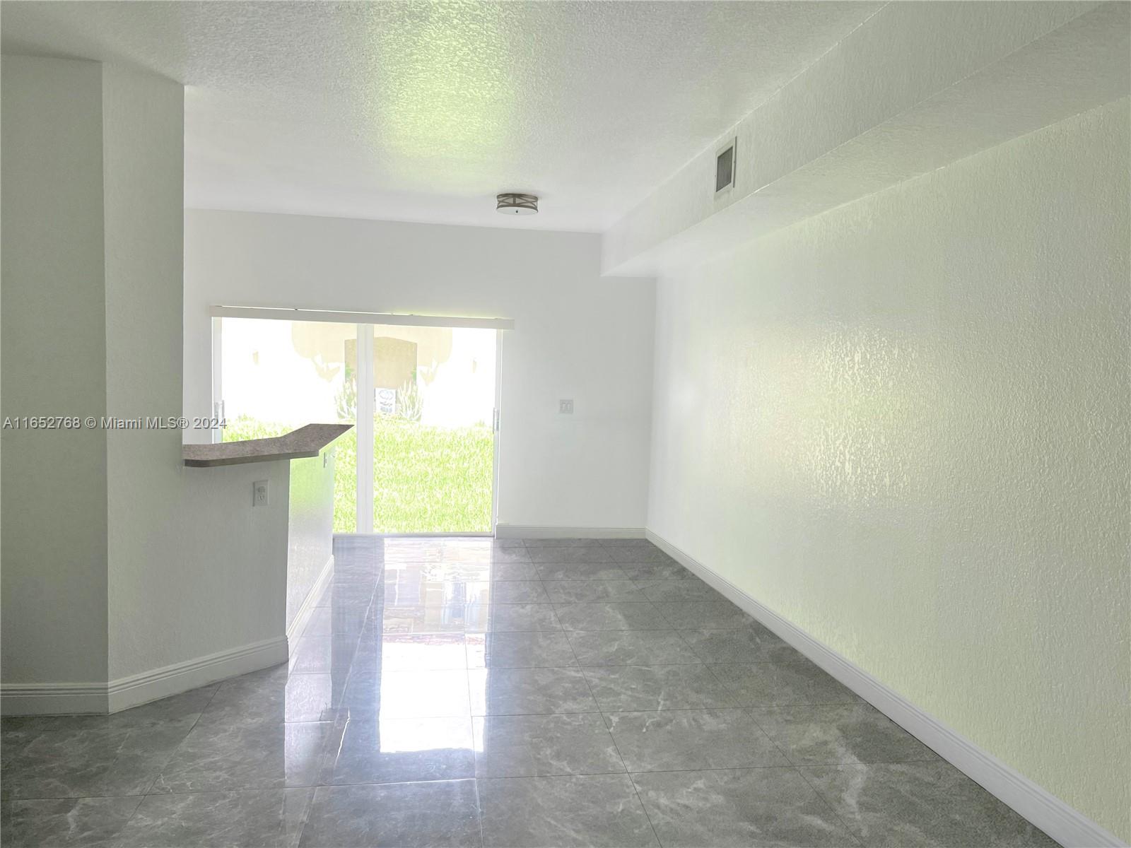 8924 West Flagler Street, Unit 2 Miami, FL 33174 - Photo 4 of 7 an empty room with windows