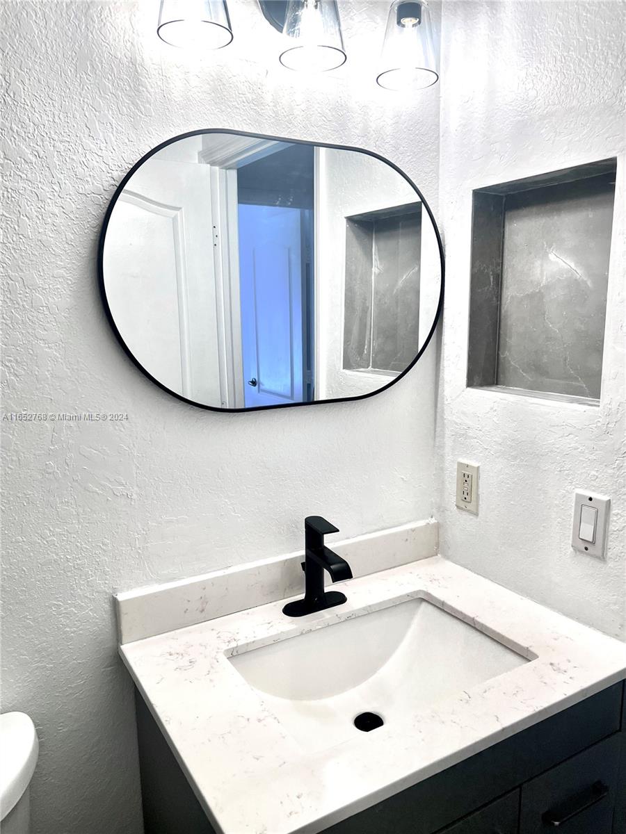 8924 West Flagler Street, Unit 2 Miami, FL 33174 - Photo 5 of 7 a bathroom with a sink and mirror