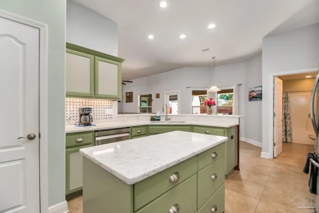 a kitchen with a stove a sink and a refrigerator