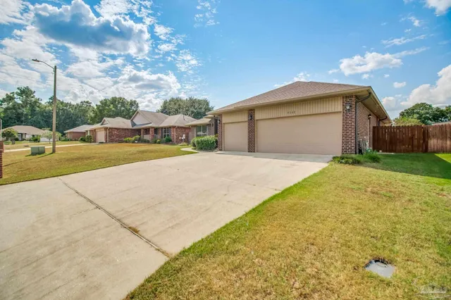 a view of a house with a yard and garage
