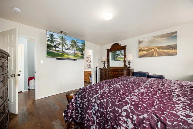 a bedroom with a bed and a dresser in it