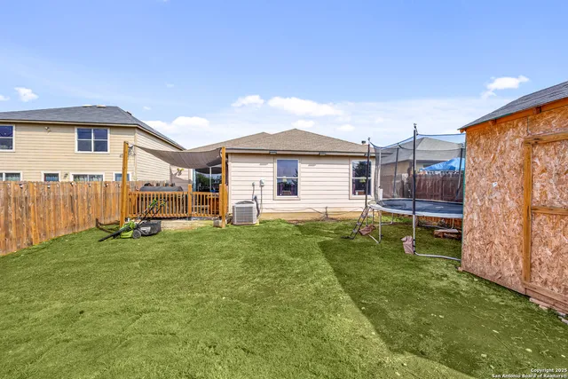 a view of a house with a backyard and a patio