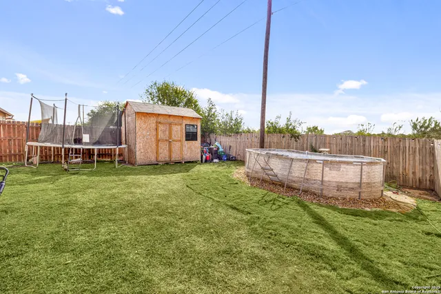 a view of a house with a yard and deck