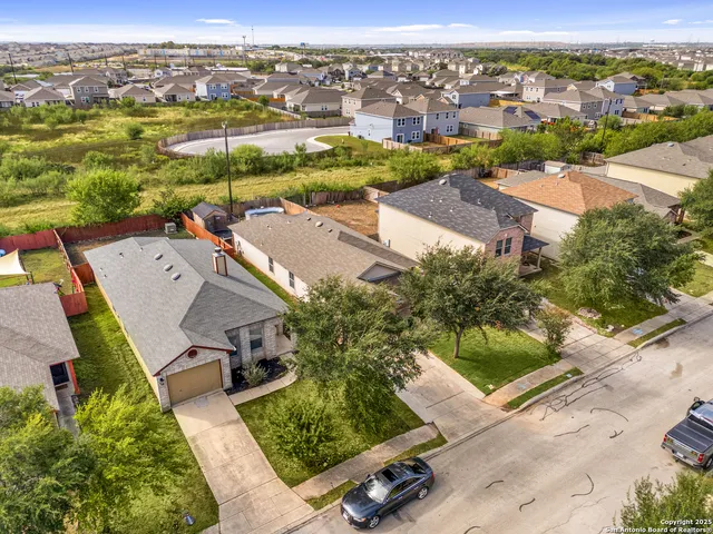 an aerial view of residential houses with outdoor space