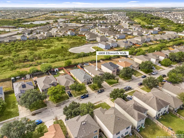an aerial view of residential houses with outdoor space