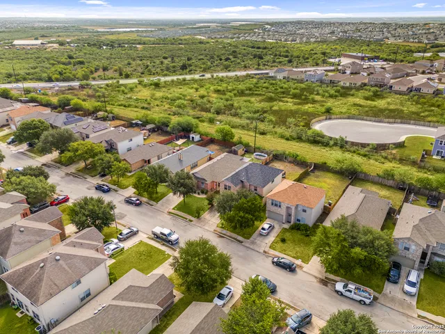 an aerial view of residential houses with outdoor space