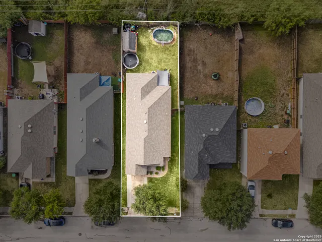 an aerial view of residential house with outdoor space and parking