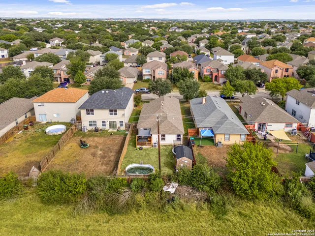 an aerial view of residential houses with outdoor space
