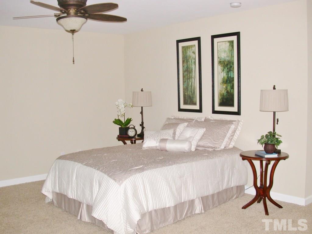 11604 Chipaway Court Raleigh, NC 27614 - Photo 13 of 25 a bedroom with a bed and a table